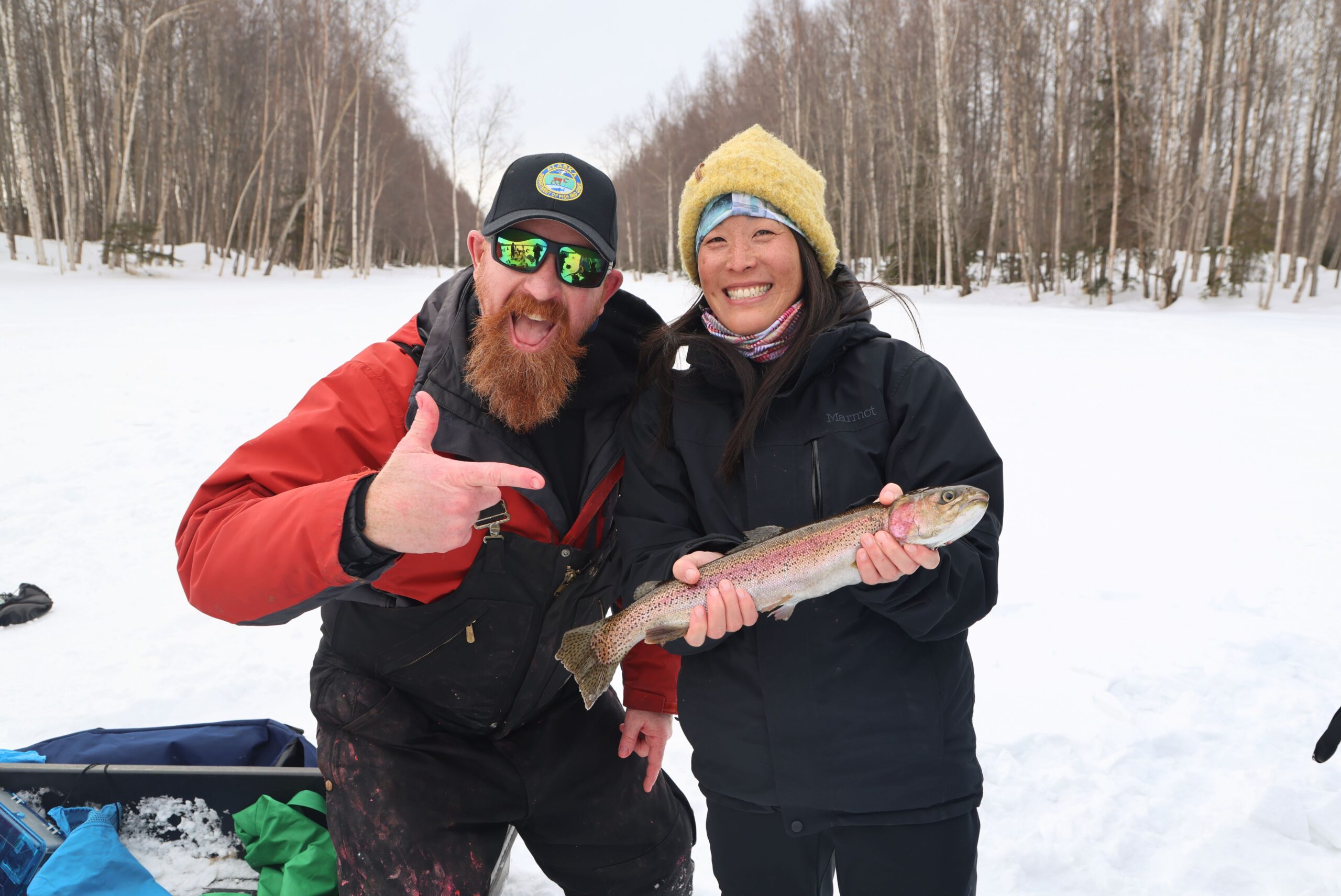 1I4A0511 ADF&G Staff member and ice fishing class participant holding a rainbow trout